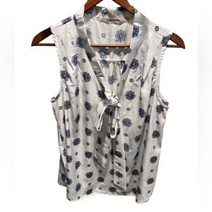 41 Hawthorn blue and white sleeveless blouse with button front and tie neckline